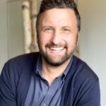 a man with a beard and a blue shirt