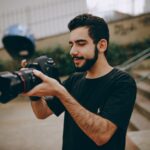Photo of Man Taking Photo Using a Dslr Camera